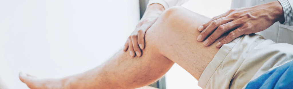 Orthopedic care provider examining a patient's leg